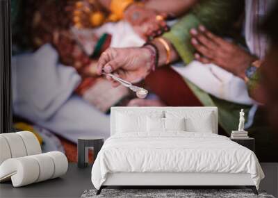 Indian wedding | Bride's Dad holding spoon tradition Wall mural