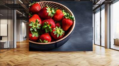 there are strawberries in a wooden bowl on black table Wall mural