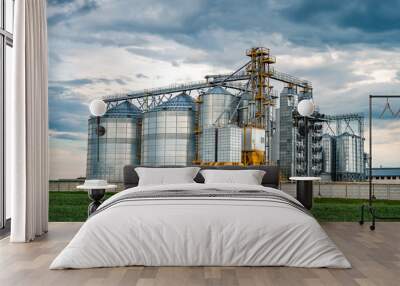 agro-processing plant for processing and silos for drying cleaning and storage of agricultural products, flour, cereals and grain with beautiful clouds Wall mural