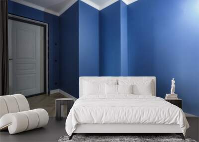 Empty unfurnished corridor with minimal preparatory repairs with crown moulding. interior of white and blue walls Wall mural