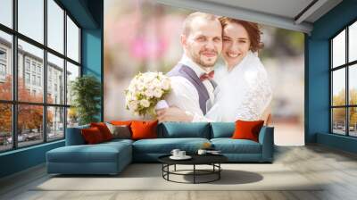 loving couple of newlyweds walks in the old city in summer sunny day Wall mural