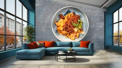 Modern style traditional Italian ragu alla bolognese sauce with papedelle pasta noodles and parmesan cheese served as top view in a ceramic design bowl with copy space Wall mural