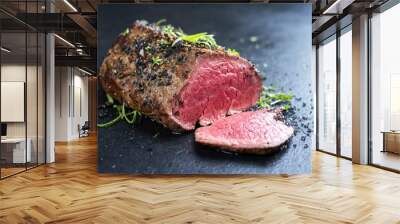 Traditional barbecue dry aged wagyu fillet steak with herb and spice marinated as closeup on a black board Wall mural