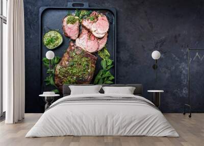 Traditional English barbecue lamb roast sliced with mint leaf and sauce offered as top view in a design cast-iron tray with copy space right Wall mural