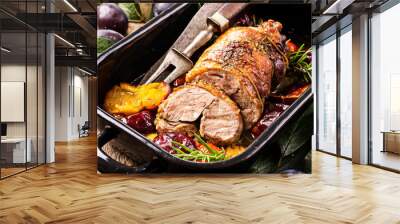 Traditional French barbecue lamb roast with vegetable and plums served as close-up in a rustic casserole Wall mural