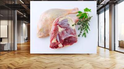 Traditional raw gourmet duck leg offered with herbs as close-up on a white background with copy space Wall mural