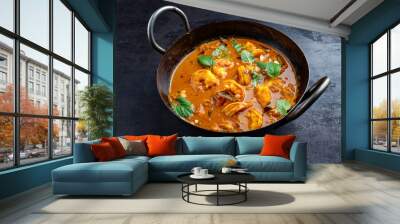 Traditional spicy Indian prawn Madras curry Rogan Josh with king prawns served as close-up in a korei bowl Wall mural