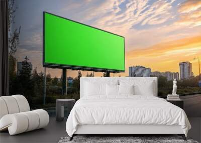 A mockup of a green screen billboard advertisement placed on the side of the road. Wall mural