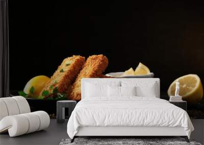 A close up view of fresh fish fingers coated in breadcrumbs served with sauce and a slice of lemon on a grey table providing ample copy space for the image Wall mural