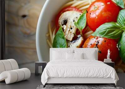 A dish of spaghetti garnished with three tomatoes and mushrooms creating a visually appealing meal with copy space image Wall mural