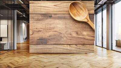 A large wooden spoon displayed against a wooden backdrop with copy space image Wall mural