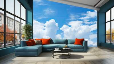 A picturesque scene of blue skies dotted with fluffy white clouds offering ample copy space for your artistic needs Wall mural