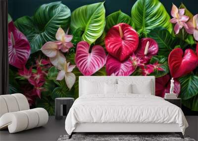 A top down view of a creatively arranged composition featuring vibrant tropical leaves and anthurium flowers perfect for use as a copy space image Wall mural