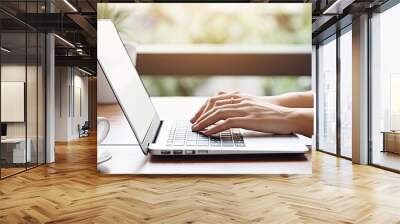 A woman working from home on a laptop with a blank screen The computer rests on a table Room for text Wall mural