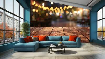 A wooden table is displayed in a blur of a modern night scene at a bustling restaurant offering a generous copy space image for presenting products or food Wall mural