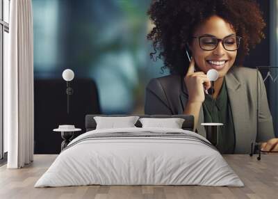 African American businesswoman smiles while working speaking on the phone and making notes in her office Wall mural