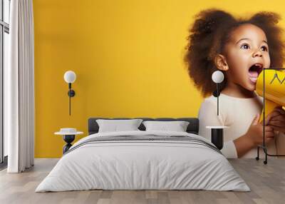 African American girl shouting sharing news with copy space on yellow studio background Wall mural