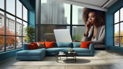 Afro businesswoman multitasking in a modern office Wall mural