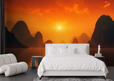 Blurred river and karst formation mountains with bright orange sky at sunset in Xingping China typical of Yangshuo s terrain Wall mural