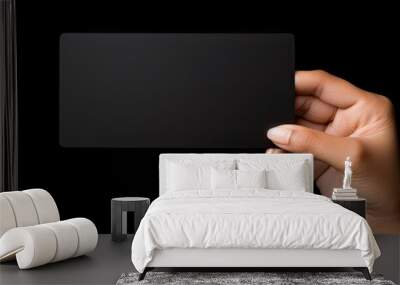 Caucasian woman s hand holds black business card on black background Symbolizes business and writing space Wall mural