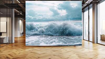 Cloudy skies overlook ocean waves creating white foam splashes in the background, providing a serene copy space image. Wall mural