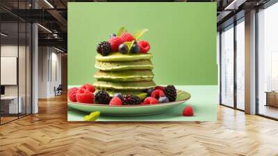 Colorful background with a plate featuring delicious green pancakes topped with berries perfect for a copy space image Wall mural