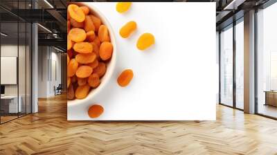 Copy space image of a top view bowl filled with dried apricots on a white background offering a healthy and nutritious fruit option Wall mural