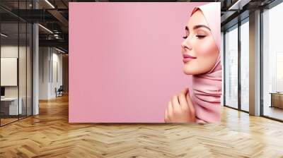 Curious Muslim woman in headscarf interested Arab female wearing hijab pink studio background with copy space Wall mural