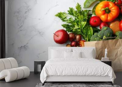 Fresh fruits and vegetables in a paper bag showcased on a white marble backdrop in a flat lay style perfect for adding text to the copy space image Wall mural