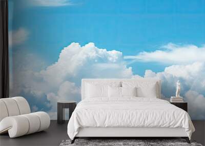 In spring a serene copy space image reveals a pale blue sky adorned with picturesque white fluffy clouds Wall mural