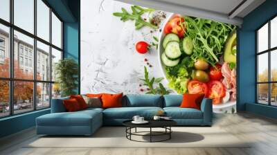 Keto dinner plate with boiled pork avocado guacamole tomatoes cucumbers mozzarella olives and arugula on a white table Detox and health concept Shot from the top showing a copy space image Wall mural