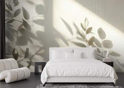 Leaves shadows gently fall on a blank wall creating a stylish copy space image suitable for decorative purposes Wall mural