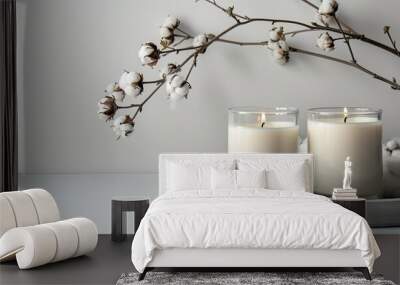 Minimalistic presentation with a concrete tray holding white candles in glass jars paired with delicate cotton flowers suitable for a mockup with ample copy space image Wall mural