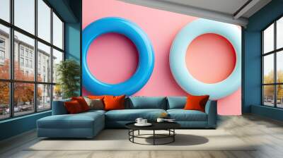 photo of pink and blue rings on a vibrant pink background with plenty of copy space with copy space Wall mural