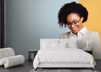 Pleased African American businesswoman with tablet on light background empty area Wall mural