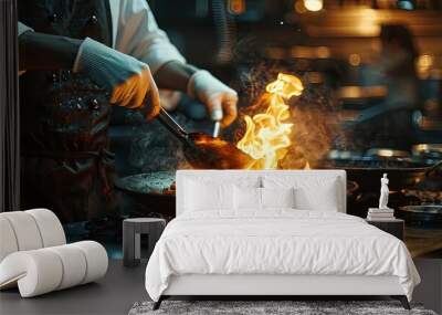 Professional chef wearing gloves and apron cooking stir fry flambe holding a pan with open fire in a dark restaurant kitchen. Creative Banner. Copyspace image Wall mural