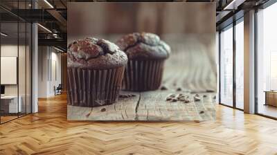 Selective focus on a wooden table showcasing two dark chocolate muffins with ample copy space in the image Wall mural