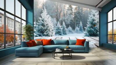 Snow covered forest with snow covered fir trees on wooden flooring in a winter Christmas landscape perfect for a copy space image Wall mural