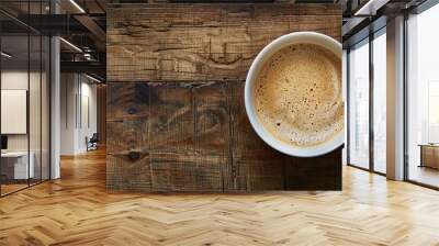 Top-down view of a warm cappuccino in a cup on a wooden table with ample copy space image available. Wall mural