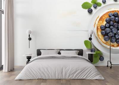 Top view of a copy space image featuring light background with cottage cheese pancakes sour cream and blueberries Suitable for breakfast or lunch Wall mural