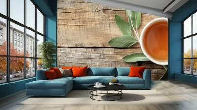 Top view of a cup of fragrant herbal tea with sage on a wooden table ideal for adding text Includes copy space image Wall mural