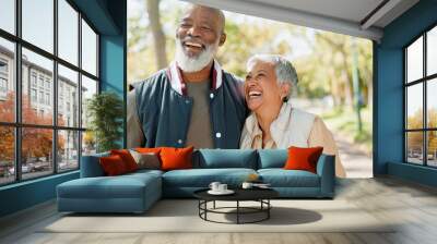 Love, laugh and senior couple in park for walk, exercise and fitness in retirement in nature or forest. Partner, diverse and support or trust for man and female person, care and hug or embrace Wall mural