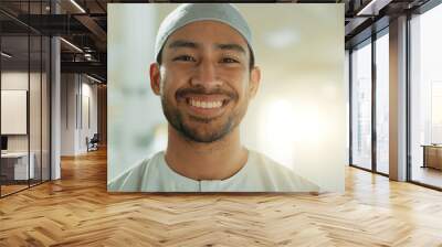 Face, smile and Muslim man in mosque on lens flare with prayer cap to worship God, Allah and praise. Portrait, happy and Islamic person in temple in hat for faith, culture and funny laugh in UAE. Wall mural