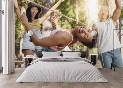 Happy, portrait and friends playing limbo for freedom, holiday games and camping activity. Smile, summer and a black woman having fun with a rope and social people while on vacation in a forest Wall mural