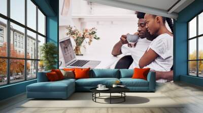 My test results should pop up anytime now...Shot of a young couple using a laptop while sitting together at home. Wall mural