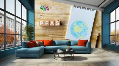 There is wood block with the word PFAS. It is an abbreviation for Per-and Polyfluoroalkyl Substances as eye-catching image. Wall mural