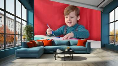 little boy drawing with color pencils Wall mural