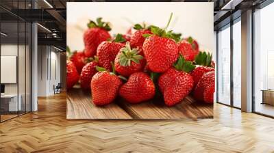 a pile of fresh ripe strawberries sitting on a wooden table Wall mural