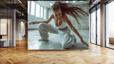 Full body shot of a woman dancing in sportswear, exuding energy and fitness. Perfect for promoting active lifestyle, exercise, and athletic apparel. Wall mural