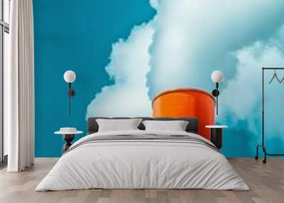 Two orange smokestacks emitting white smoke against a clear blue sky, representing pollution and industrial impact on the environment. Wall mural